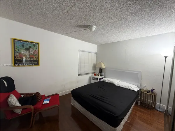 a bedroom with a bed and a dresser in it