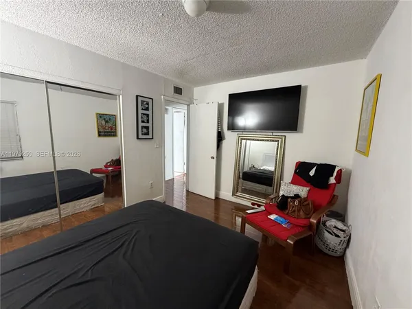 a bedroom with furniture and a flat screen tv