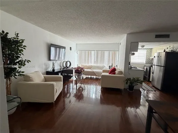 a living room with furniture or wooden floor and a window
