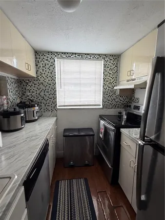 a kitchen with a sink stove and refrigerator