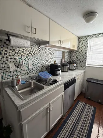 a kitchen with a sink and cabinets