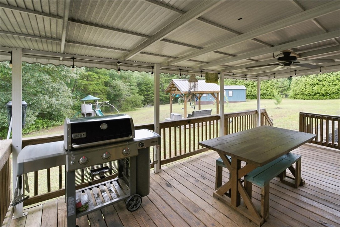 520 Sharon Lane Seneca, SC 29678 - Photo 33 of 48 An inviting covered patio offers ample space for outdoor dining and entertaining amidst a verdant backyard setting.