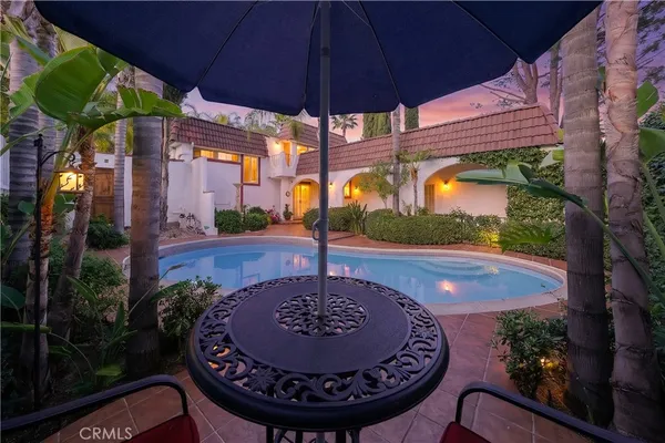a view of a patio with table and chairs with potted plants