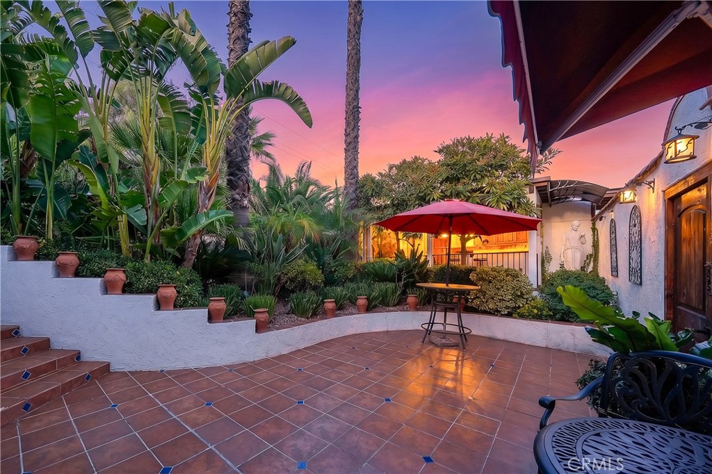 23734 Vista Ramona Road Ramona, CA 92065 - Photo 14 of 62 a backyard of a house with table and chairs under an umbrella