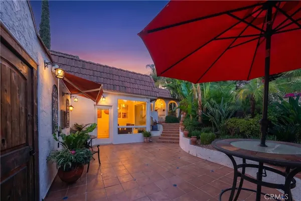 a view of a porch with chairs and potted plants