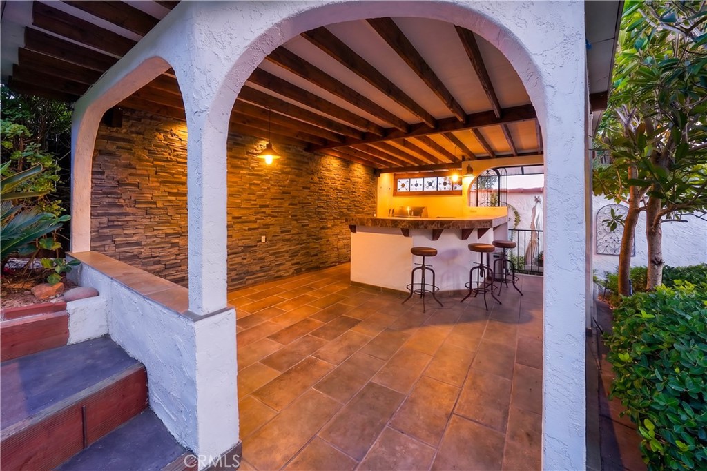 23734 Vista Ramona Road Ramona, CA 92065 - Photo 18 of 62 a view of a patio with table and chairs with potted plants