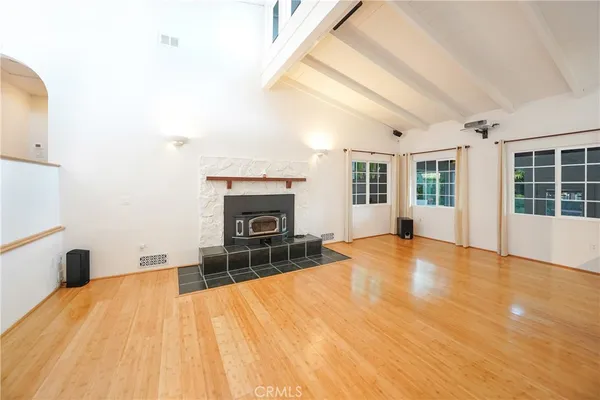 a big room with wooden floor and windows