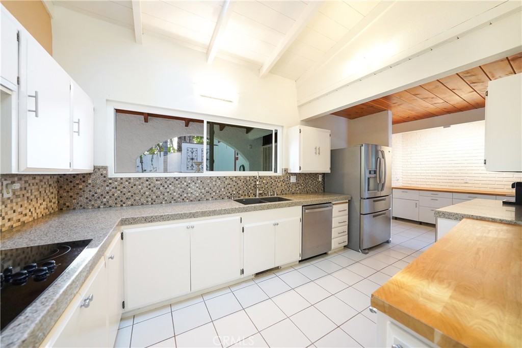 23734 Vista Ramona Road Ramona, CA 92065 - Photo 32 of 62 a kitchen with granite countertop white cabinets and white appliances