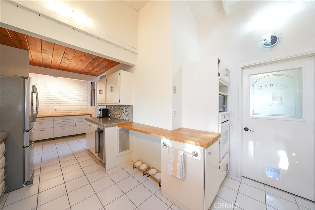 23734 Vista Ramona Road Ramona, CA 92065 - Photo 33 of 62 a large white kitchen with a large window