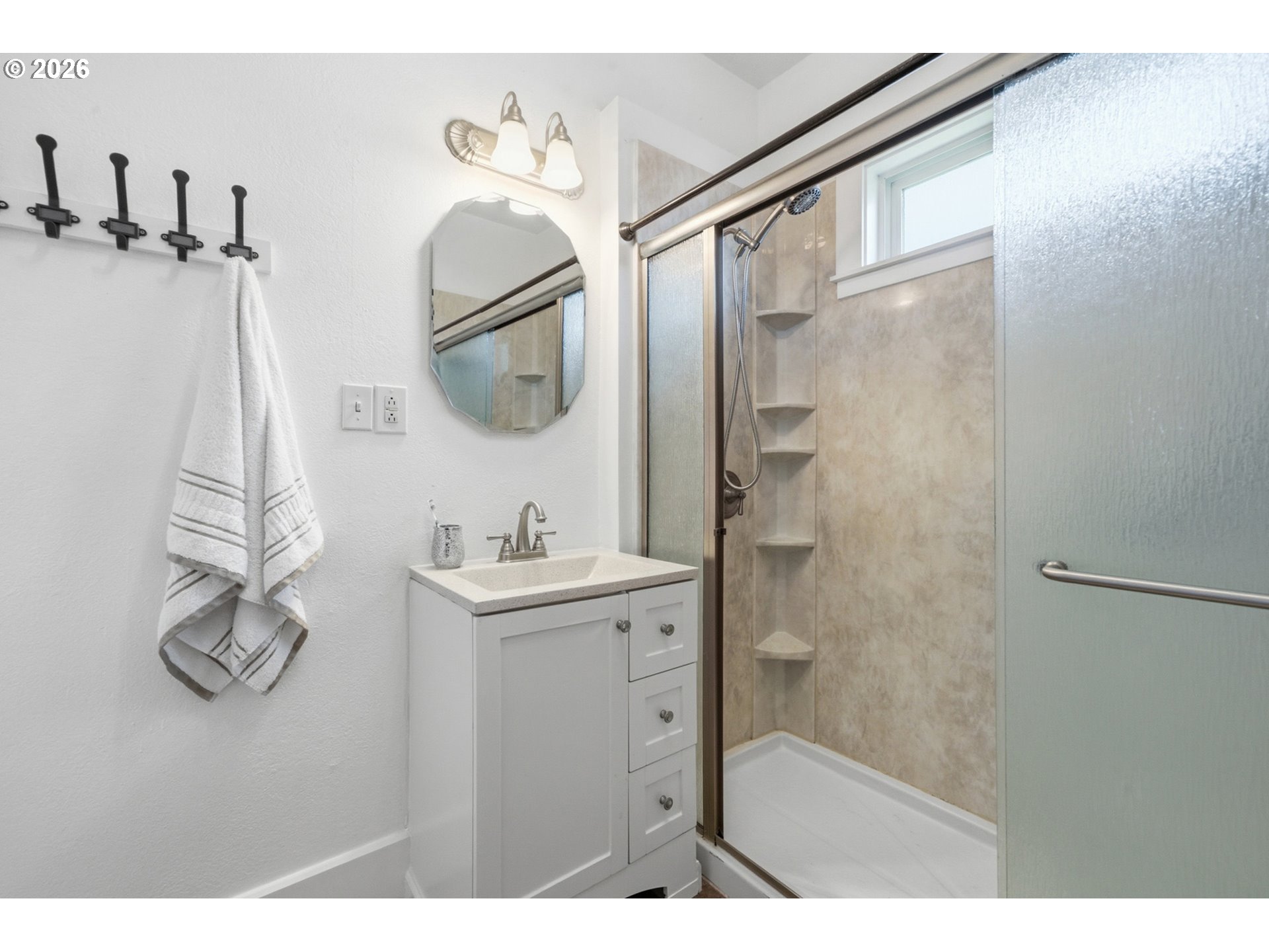 1802 8th Street Tillamook, OR 97141 - Photo 21 of 37 a bathroom with a sink and mirror