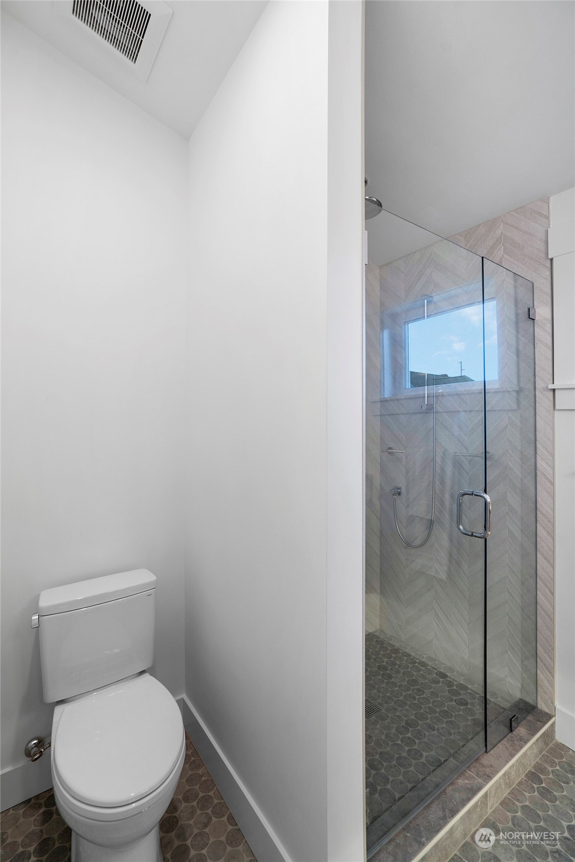 1619 3rd Avenue West Seattle, WA 98119 - Photo 13 of 28 a white toilet sitting next to a shower