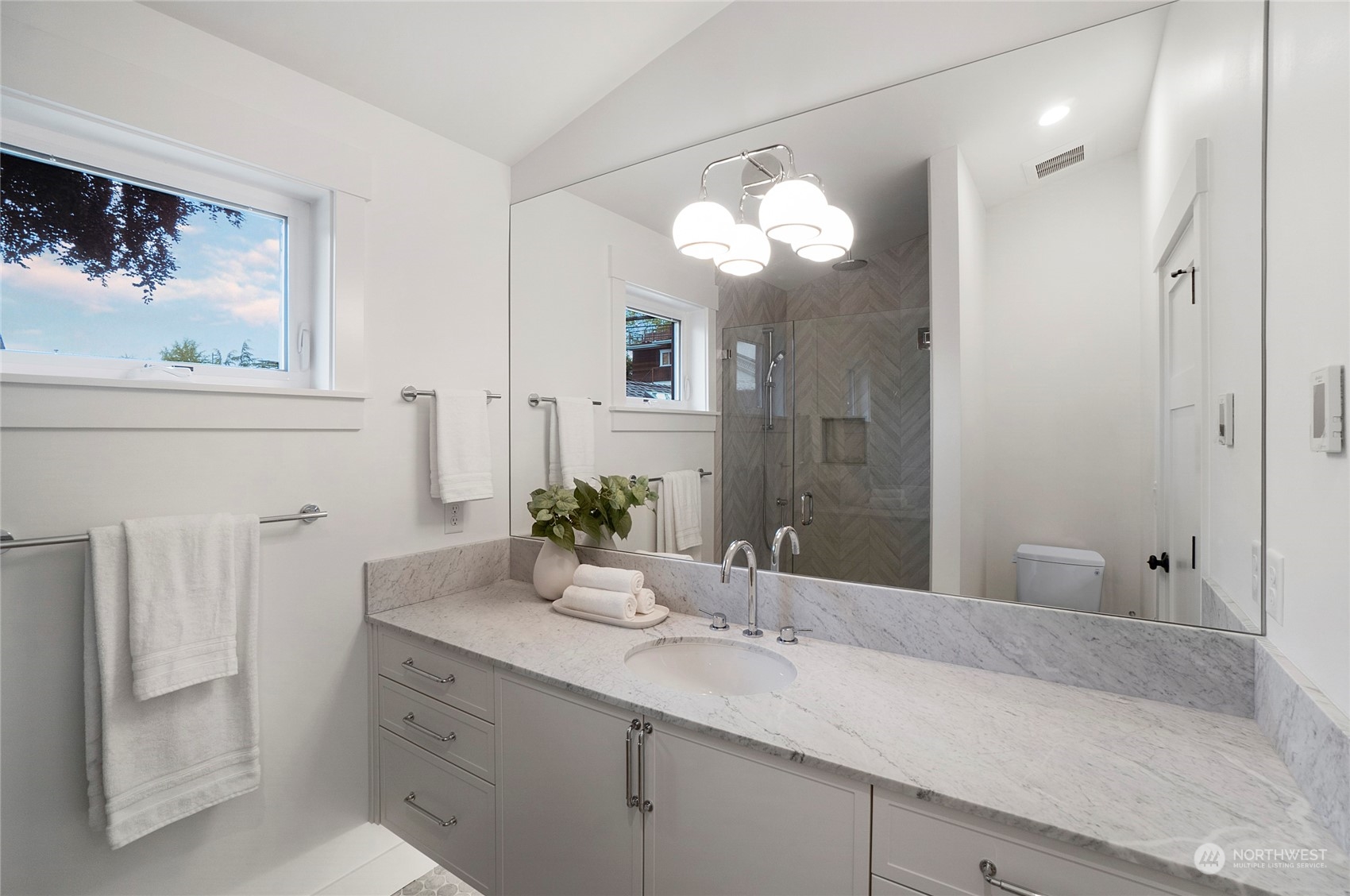 1619 3rd Avenue West Seattle, WA 98119 - Photo 14 of 28 a bathroom with a granite countertop sink a large mirror and a shower