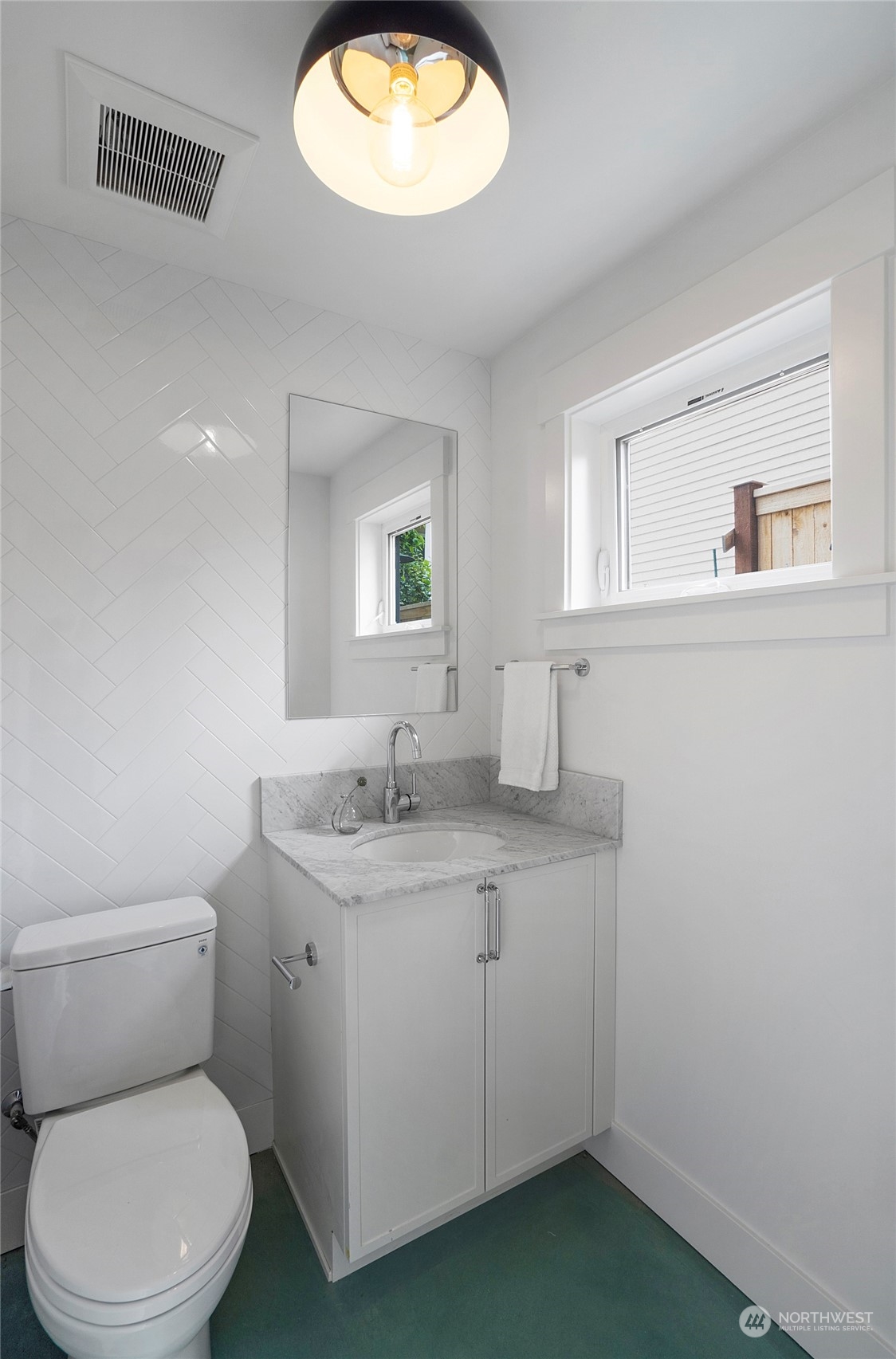 1619 3rd Avenue West Seattle, WA 98119 - Photo 9 of 28 a bathroom with a toilet sink and mirror