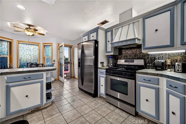 a kitchen with stainless steel appliances granite countertop a sink and cabinets