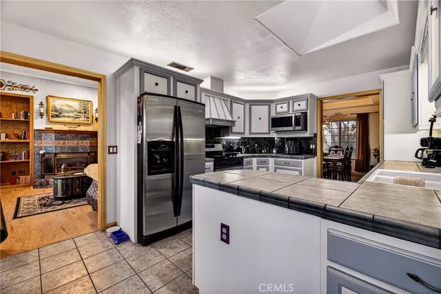 a living room with fireplace furniture and a flat screen tv