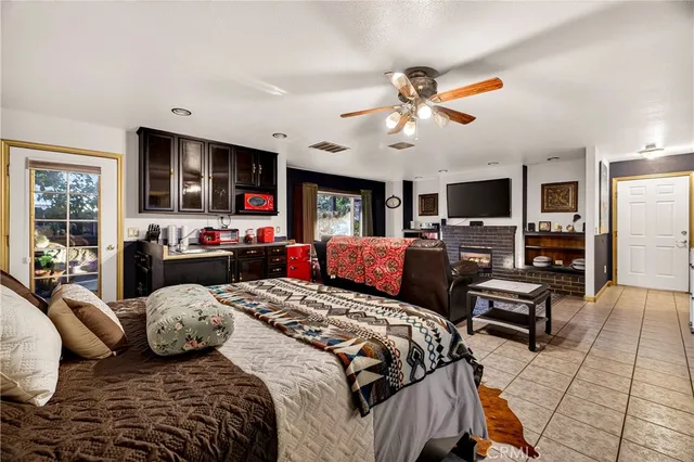 a living room with fireplace furniture and a large window
