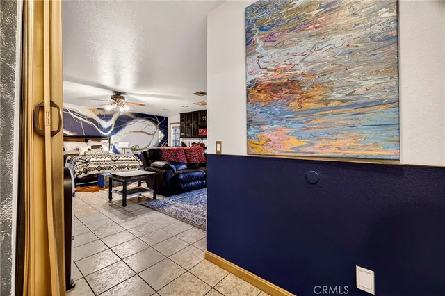 a view of a livingroom with workspace and a window