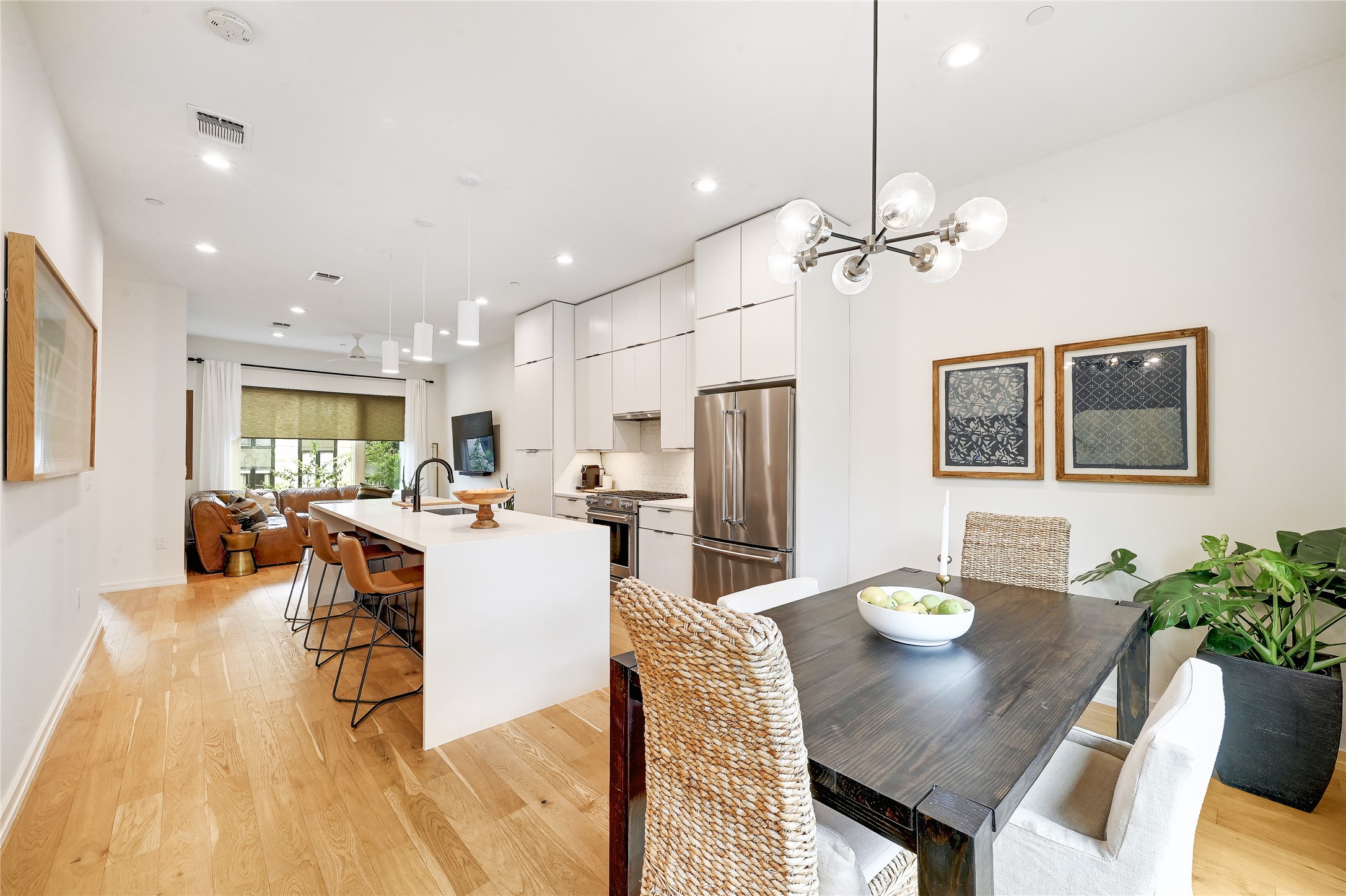 a view of a dining room with furniture a chandelier and wooden floor