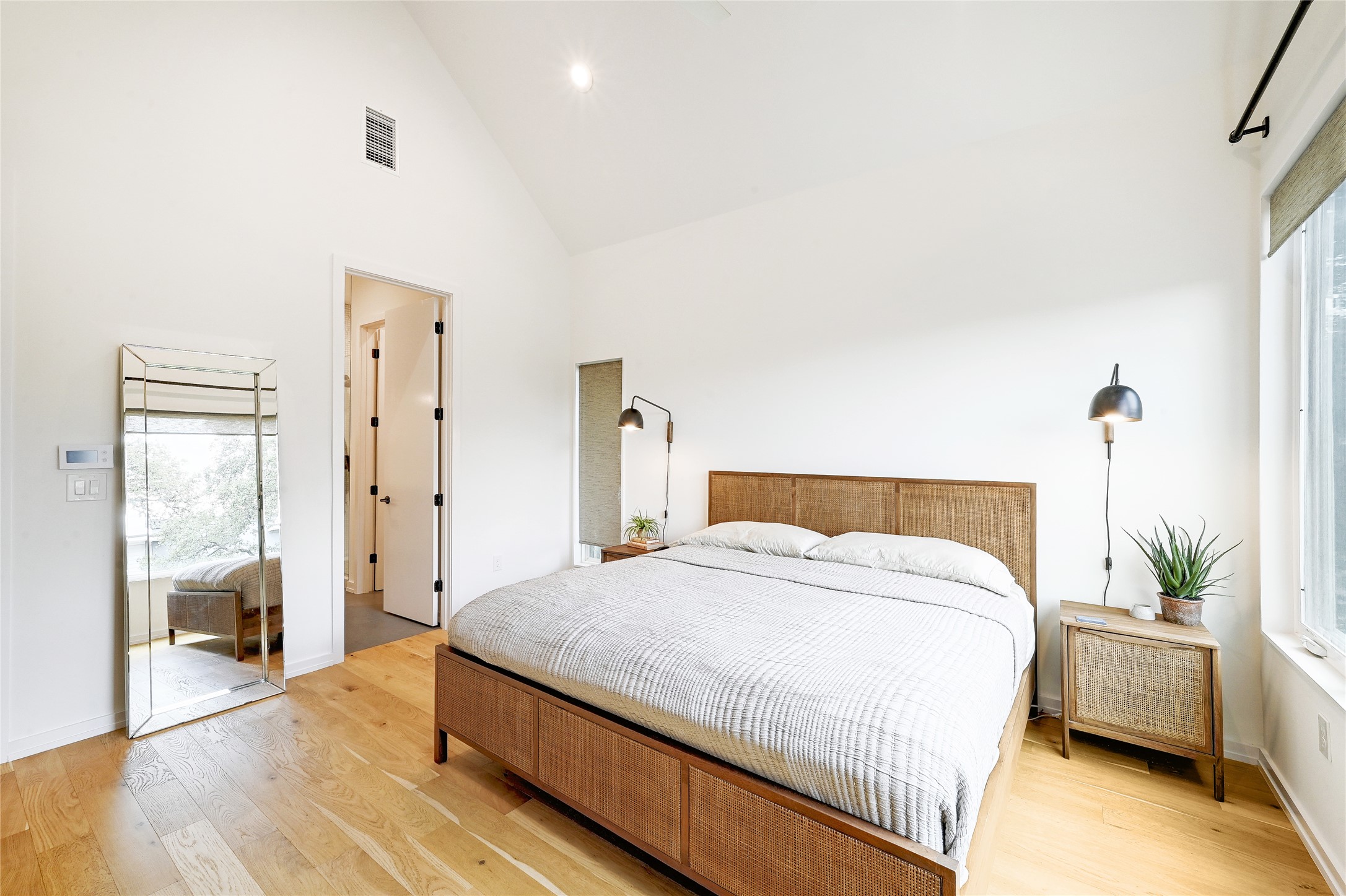 410 West Alpine Road, Unit 7 Austin, TX 78704 - Photo 11 of 26 a spacious bedroom with a bed and wooden floor