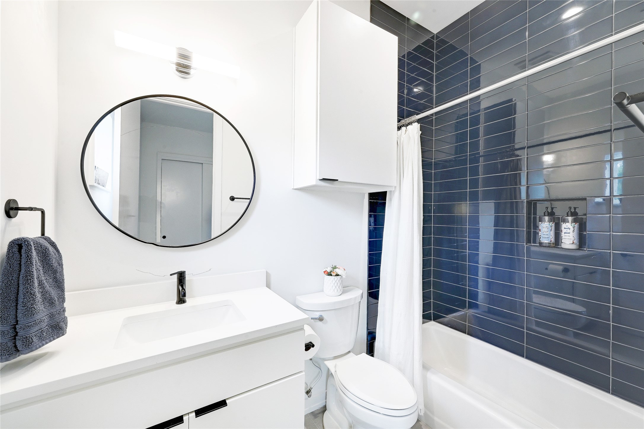 410 West Alpine Road, Unit 7 Austin, TX 78704 - Photo 15 of 26 a bathroom with a sink a toilet and a mirror