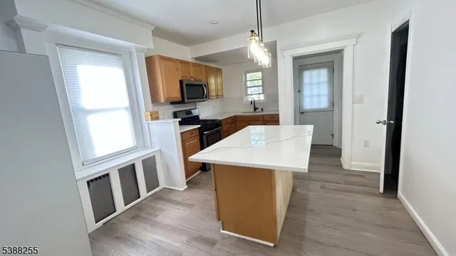 a view of kitchen with sink and wooden floor
