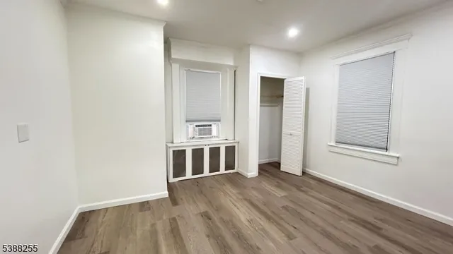 a view of a kitchen with wooden floor and a window