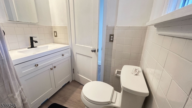 354 West 2nd Street Bound Brook, NJ 08805 - Photo 7 of 10 a bathroom with a sink a toilet and shower curtain