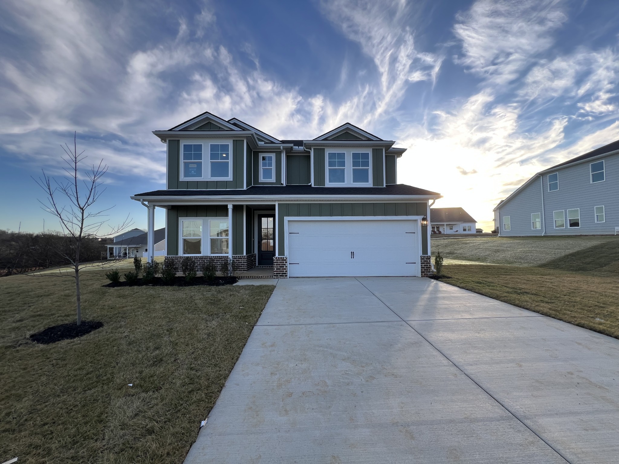 a front view of a house with a yard and garage