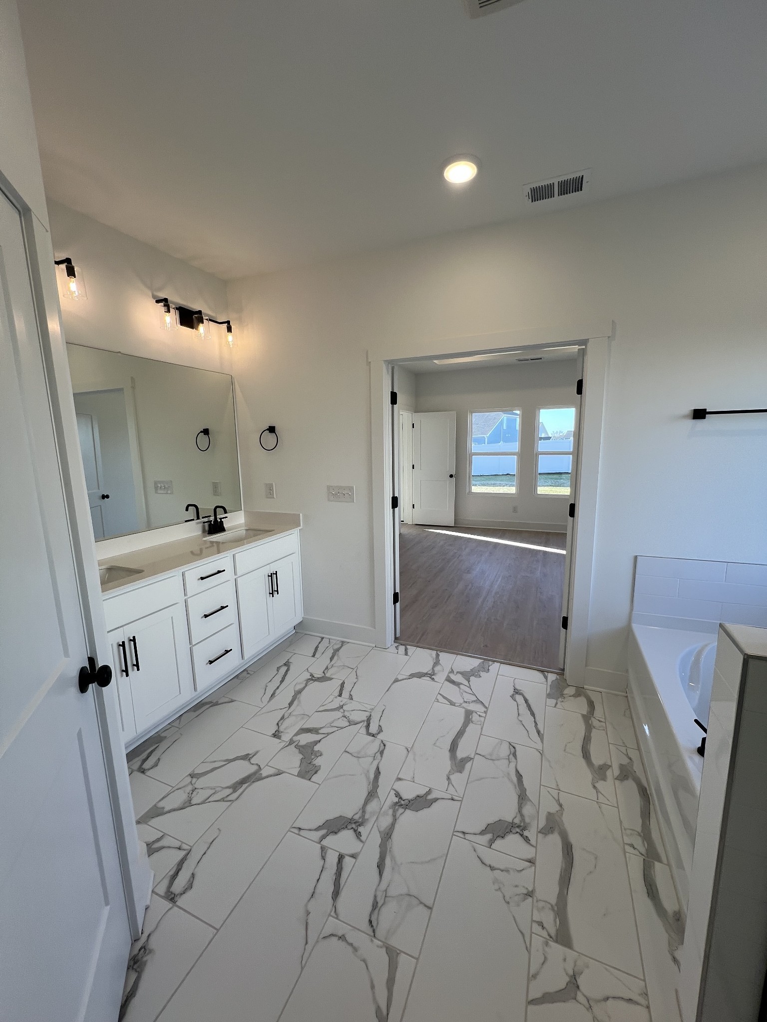 304 Strong Street Columbia, TN 38401 - Photo 13 of 49 a spacious bedroom with a large bed and a mirror