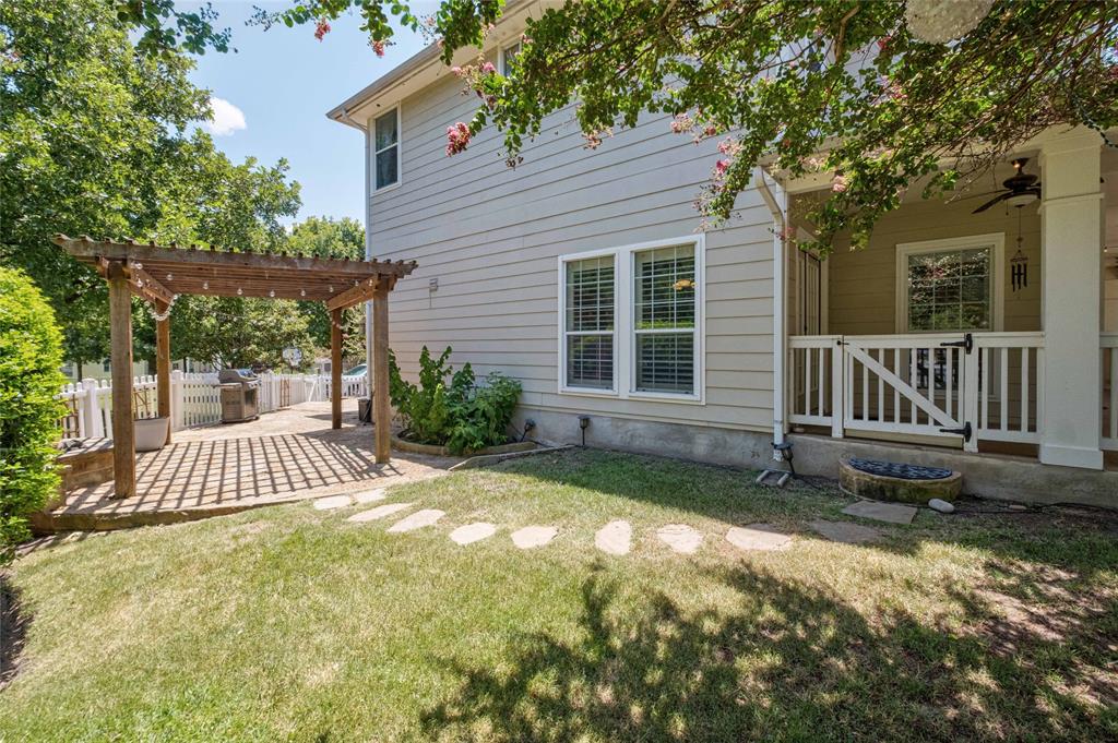 2730 Kinney Oaks Court Austin, TX 78704 - Photo 25 of 32 Mature trees shade a charming paved patio area beneath a classic wooden pergola structure.