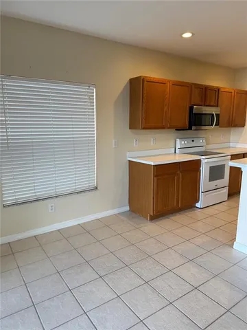 a kitchen with stainless steel appliances a stove a sink and a microwave