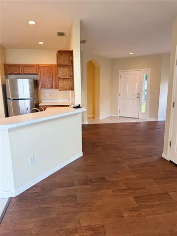 a large kitchen with stainless steel appliances granite countertop a stove and a refrigerator