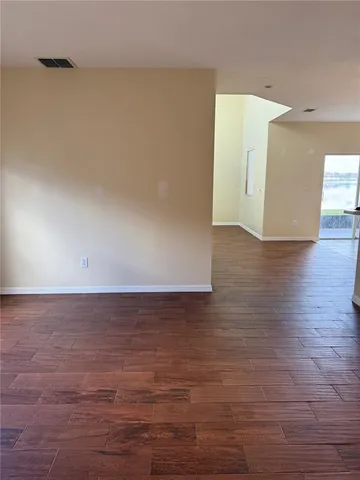 a view of room with wooden floor