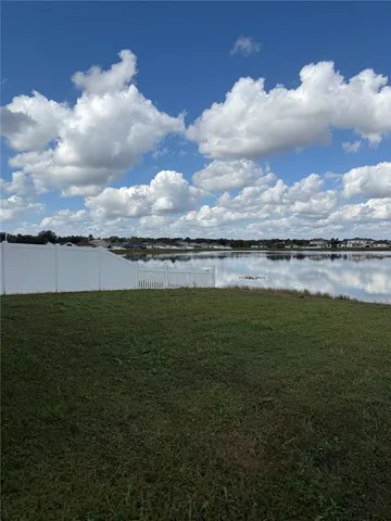 a view of a lake with houses in the back