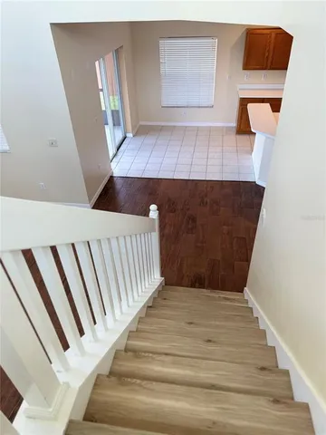 a view of a hardwood floor and staircase
