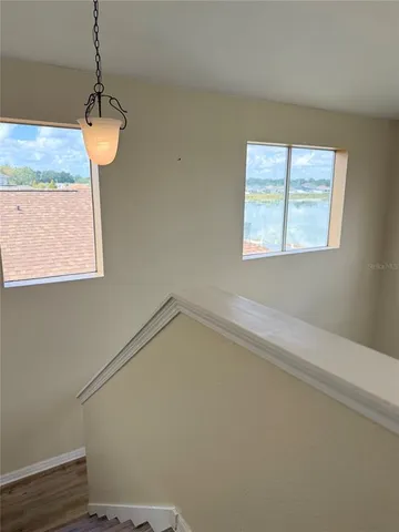 a room with a chandelier and a window