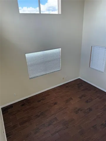 a view of room with wooden floor and fan