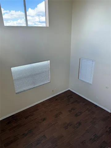 an empty room with wooden floor