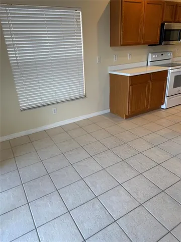 a view of a kitchen with washing machine and a sink