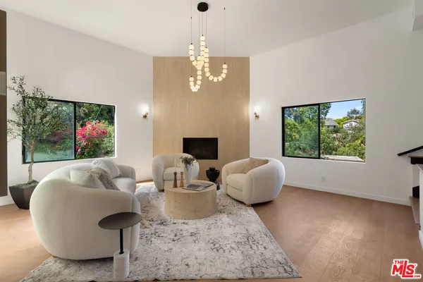 a living room with fireplace furniture and a flat screen tv
