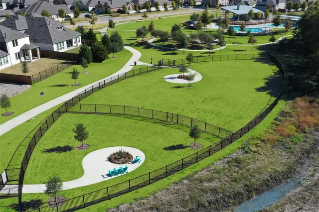 an aerial view of residential houses with outdoor space and swimming pool