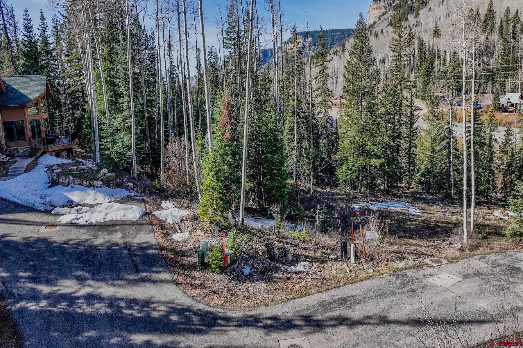 30 Grand Turk Court Durango, CO 81301 - Photo 2 of 10 a view of a wooden house with a yard and trees
