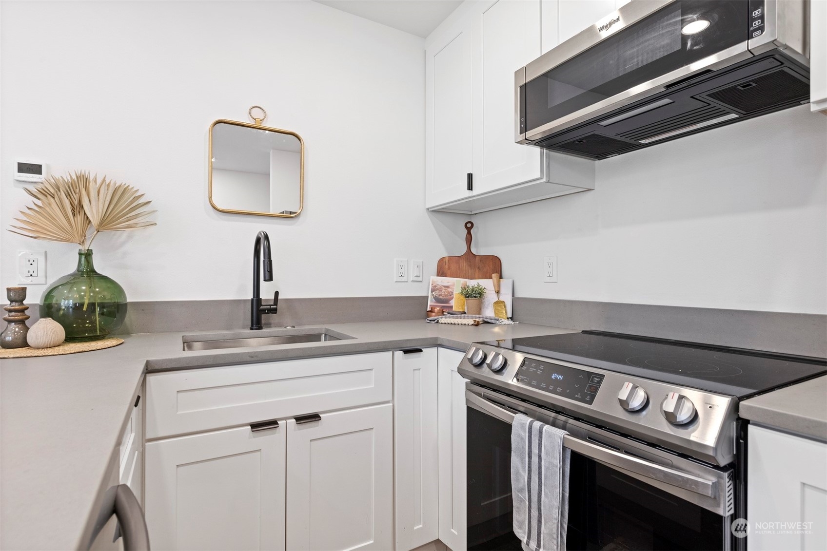 2415 Pacific Street Bellingham, WA 98229 - Photo 11 of 40 a kitchen with stainless steel appliances a sink and cabinets