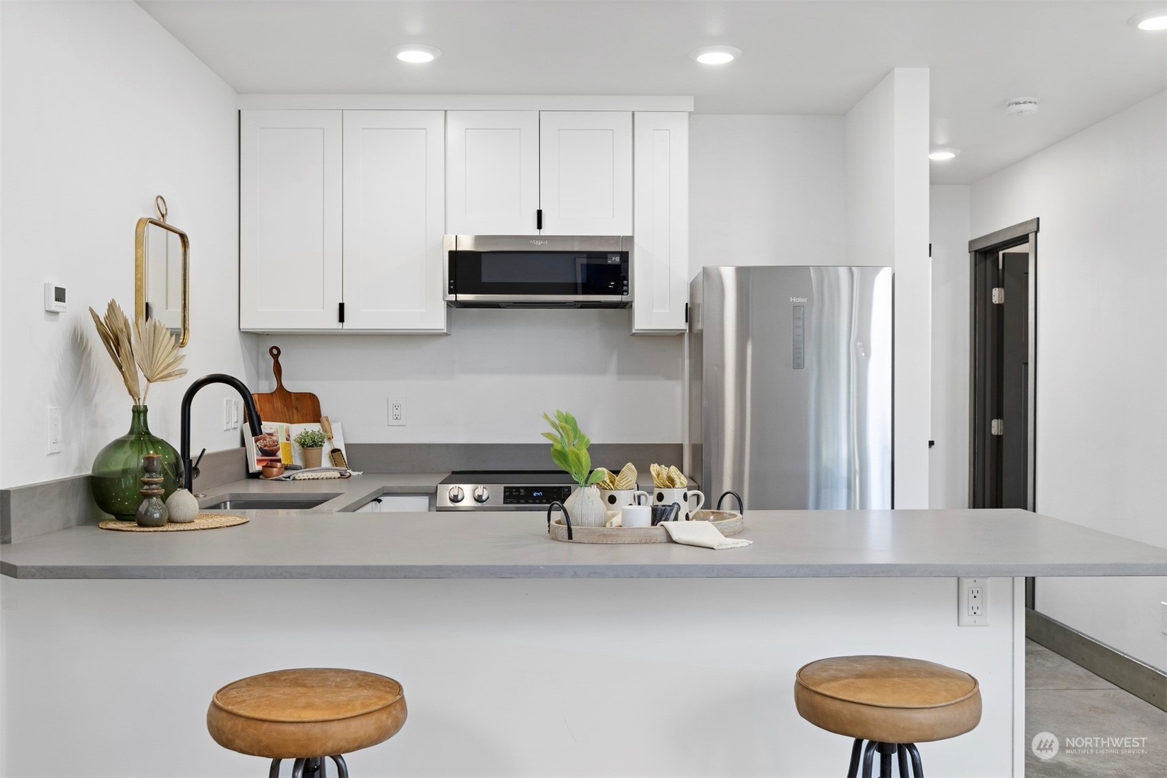 2415 Pacific Street Bellingham, WA 98229 - Photo 12 of 40 a kitchen with stainless steel appliances a sink a refrigerator and a counter space