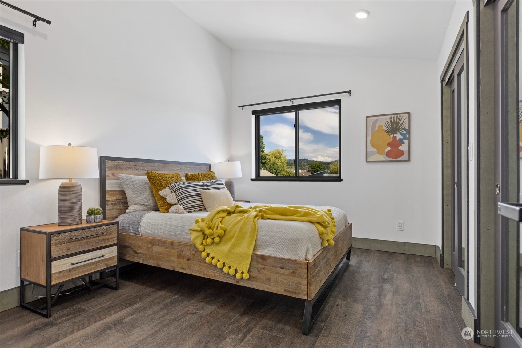 2415 Pacific Street Bellingham, WA 98229 - Photo 20 of 40 a bedroom with a bed and wooden floor