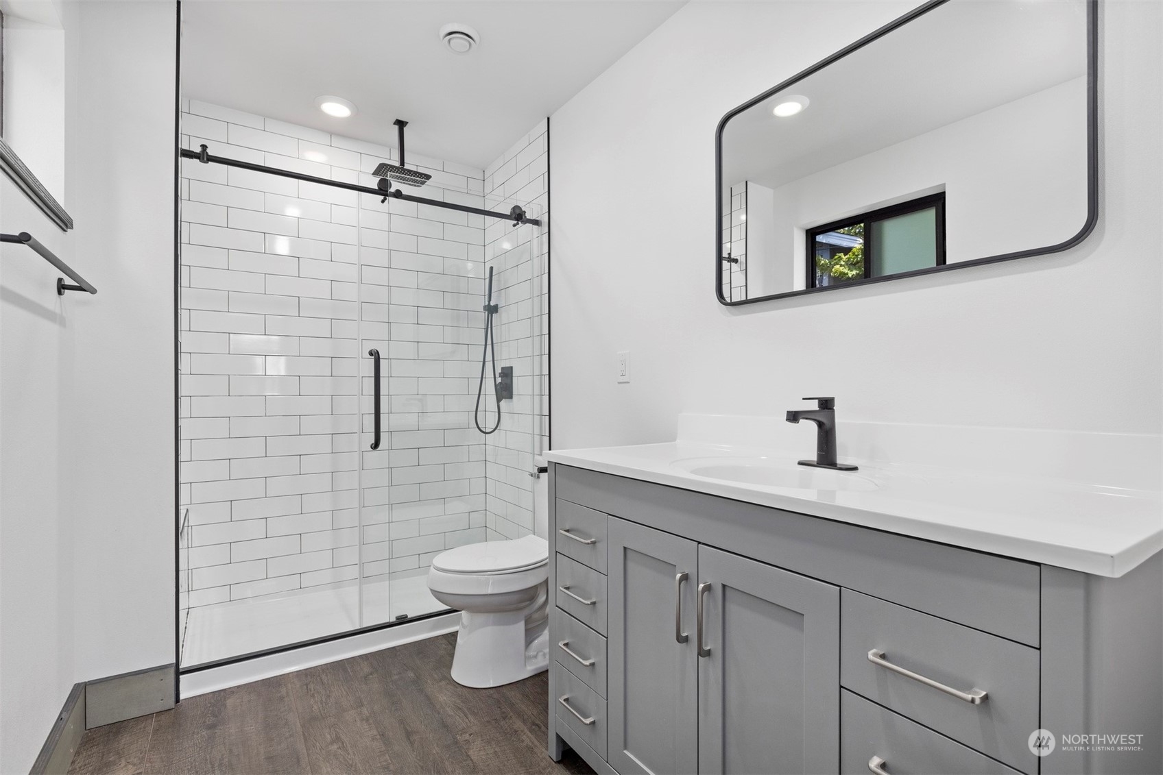 2415 Pacific Street Bellingham, WA 98229 - Photo 36 of 40 a bathroom with a granite countertop sink a toilet and a mirror