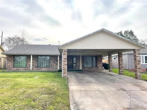 a view of a brick house with a yard