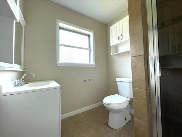 a bathroom with a toilet sink and a window
