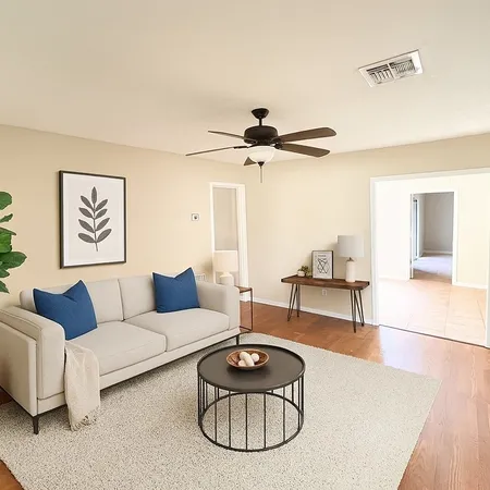 a living room with furniture and a wooden floor