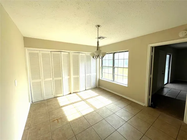 a view of an empty room with glass door